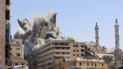 Smoke billows as Israeli airstrikes destroy the al-Ghafari tower in Gaza City. (Omar al-Qattaa/AFP) Smoke billows as Israeli airstrikes destroy the al-Ghafari tower in Gaza City. (Omar al-Qattaa/AFP)