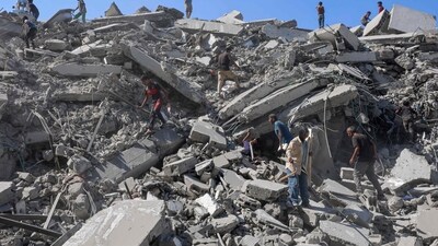 Palestinians search the rubble of al-Ghafari tower after its destruction by Israeli airstrikes in Gaza City. (Omar al-Qattaa/AFP) Palestinians search the rubble of al-Ghafari tower after its destruction by Israeli airstrikes in Gaza City. (Omar al-Qattaa/AFP)