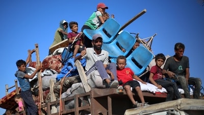Displaced Palestinians move with their belongings southwards on a road in the Nuseirat refugee camp area in the central Gaza Strip following renewed Israeli evacuation orders. (Eyad Baba/AFP) Displaced Palestinians move with their belongings southwards on a road in the Nuseirat refugee camp area in the central Gaza Strip following renewed Israeli evacuation orders. (Eyad Baba/AFP)