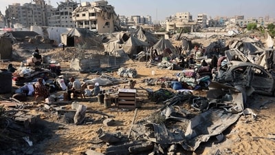 Displaced Palestinians check what remains of their tents, following an overnight Israeli strike that levelled a building and damaged the surrounding temporary shelters, in the Rimal neighbourhood of Gaza City. (Omar al-Qattaa/AFP) Displaced Palestinians check what remains of their tents, following an overnight Israeli strike that levelled a building and damaged the surrounding temporary shelters, in the Rimal neighbourhood of Gaza City. (Omar al-Qattaa/AFP)