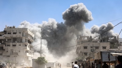 Palestinians watch as the Mhanna tower collapses amid heavy smoke, during an Israeli strike in the Tal el-Hawa neighbourhood of Gaza City. (Omar al-Qattaa/AFP) Palestinians watch as the Mhanna tower collapses amid heavy smoke, during an Israeli strike in the Tal el-Hawa neighbourhood of Gaza City. (Omar al-Qattaa/AFP)