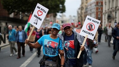 Supporters of former US President Barack Obama hold signs on the day of a 'Trump Not Welcome' protest during the state visit of President Donald Trump, in London on September 17, 2025. (Reuters)