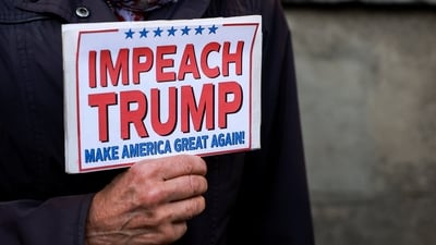 A demonstrator holds a placard during a "Trump Not Welcome" protest, ahead of U.S. President Donald Trump and first lady Melania Trump's arrival for their state visit to the country, in Windsor, Britain, September 16, 2025. REUTERS/Phil Noble (REUTERS)