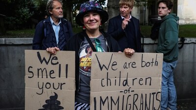 A woman holds signs during a "Trump Not Welcome" protest ahead of U.S. President Donald Trump and first lady Melania Trump's arrival for their state visit to the country, in Windsor, Britain, September 16, 2025. REUTERS/Hannah McKay (REUTERS)