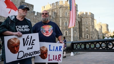 Demonstrators hold placards during a "Trump Not Welcome" protest, ahead of U.S. President Donald Trump and first lady Melania Trump's arrival for their state visit to the country, in Windsor, Britain, September 16, 2025. REUTERS/Phil Noble (REUTERS)