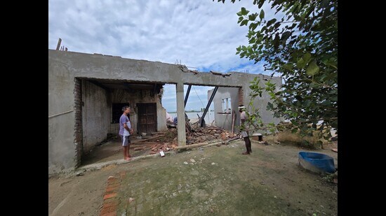 A man checks his collapsed house in Kapurthala district.