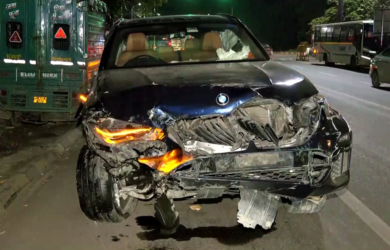 The BMW car, which collided with a couple riding a motorcycle, the husband died, and the wife sustained injuries in Dhaula Kuan, in New Delhi, on Sunday. (ANI) The BMW car, which collided with a couple riding a motorcycle, the husband died, and the wife sustained injuries in Dhaula Kuan, in New Delhi, on Sunday. (ANI)