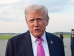 President Donald Trump speaks with reporters before boarding Air Force One at Morristown Airport, on Sunday.