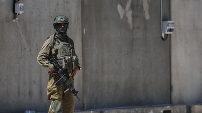 FILE: An Israeli soldier stands by during preparations at a distribution center in the southern Gaza Strip. (REUTERS)