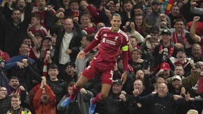 Liverpool's Virgil van Dijk celebrates after scoring his side's third goal during the Champions League match against Atletico Madrid in Liverpool. (AP)