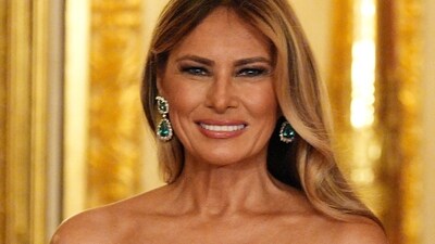First Lady Melania Trump paired the look with large emerald-and-diamond earrings.. Aaron Chown/Pool via REUTERS (via REUTERS)