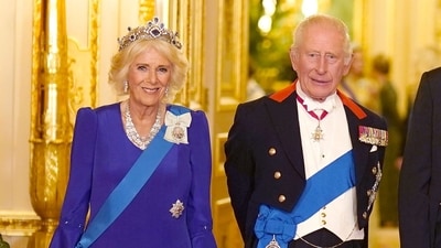 Queen Camilla opted for a royal blue silk marocain embroidered dress to attend the state banquet at Windsor Castle. Aaron Chown/Pool via REUTERS (via REUTERS)