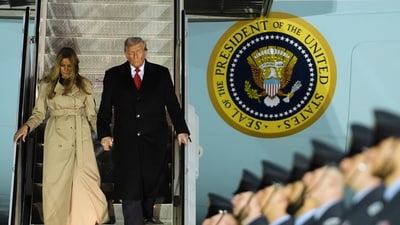 President Donald Trump and first lady Melania Trump exit Air Force One as they arrive at Stansted Airport near London, Tuesday (AP)