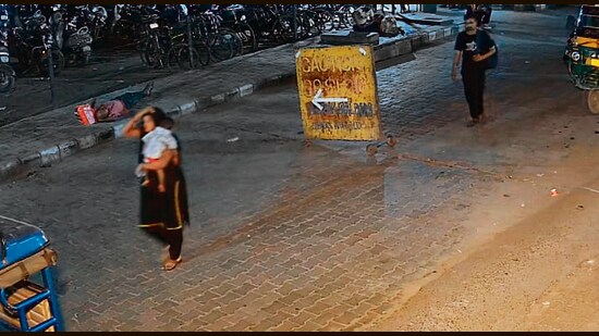 A man and a woman carrying the child (inset) seen in a footage. (HT Photo)