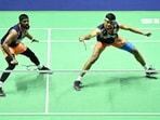 India's Satwiksairaj Rankireddy and Chirag Shetty (R) return the shuttlecock during a match.