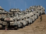 An Israeli soldier walks next to military vehicles near the border with Gaza, in Israel September 17, 2025.