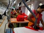 Workers iron garments at a garment facility in Bengaluru(REUTERS)
