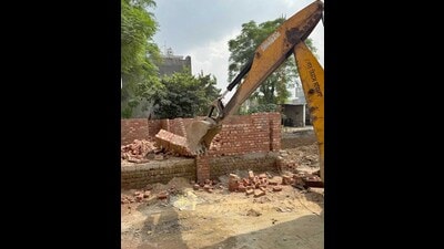 A bulldozer deployed at the demolition site in Mundian Kalan in Ludhiana on Friday. (HT Photo)