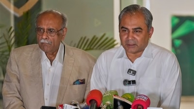 Pakistan's Interior Minister and Chairman of Pakistan Cricket Board, Mohsin Naqvi, center, speaks as former cricket board heads Najam Sethi, left, looks (AP)