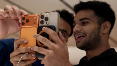 A customer compares his old iPhone with the newly launched iPhone 17 Pro Max at an Apple retail store in Delhi. (REUTERS)