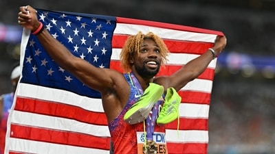 US' athlete Noah Lyles celebrates with his medal and country's flag after winning in the men's 200m final during the World Athletics Championships in Tokyo (AFP) US' athlete Noah Lyles celebrates with his medal and country's flag after winning in the men's 200m final during the World Athletics Championships in Tokyo (AFP)
