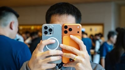 A customer looks at an Apple Inc. iPhone 17 series smartphone at the company's Sanlitun store during the first day of sales of the smartphones in Beijing, China, on Friday, Sept. 19, 2025. (Bloomberg)