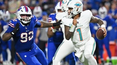 Miami Dolphins quarterback Tua Tagovailoa looks to pass against Buffalo Bills defensive tackle Daquan Jones in the first half at Highmark Stadium. (IMAGN IMAGES via Reuters Connect)