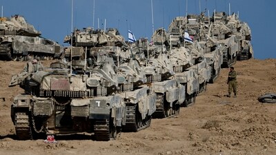 An Israeli soldier walks next to military vehicles near the border with Gaza, in Israel September 17, 2025. (Reuters)