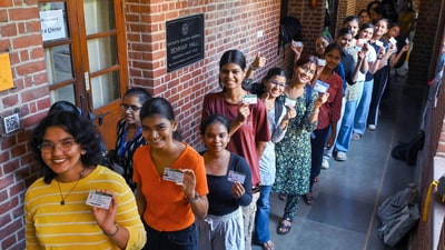 Delhi University students at Miranda House College pose with their identity cards as they wait to cast their vote for the DUSU elections. (Vipin Kumar/ANI) Delhi University students at Miranda House College pose with their identity cards as they wait to cast their vote for the DUSU elections. (Vipin Kumar/ANI)
