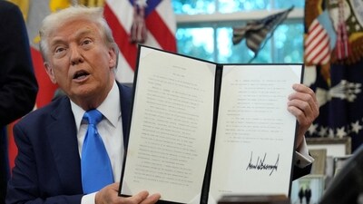 U.S. President Donald Trump displays a signed executive order on gold card visa in the Oval Office at the White House in Washington, D.C (REUTERS)
