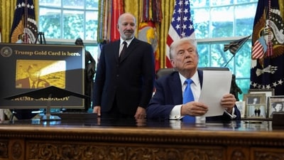 President Donald Trump with Secretary of Commerce Howard Lutnick they announce the new H-1B visa fee in the Oval Office (REUTERS)