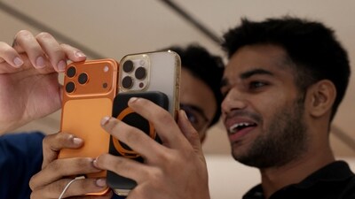 A customer compares his old iPhone with the newly launched iPhone 17 pro max at an Apple retail store (REUTERS)