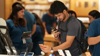 A customer takes photographs of Apple's newly launched iPhone 17 Pro smartphone as its sale begins at Select Citywalk, Saket, in New Delhi. (PTI)