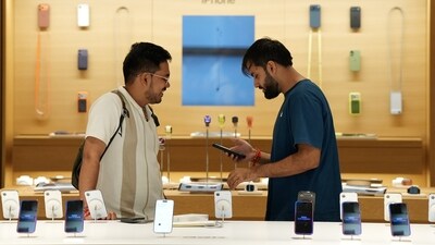 A customer interacts with an employee as sales of Apple's newly launched iPhone 17 series begin at the company's store at Select Citywalk, Saket, in New Delhi. (PTI)