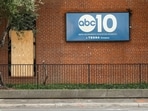 A window that was stuck by gunfire is covered with a board at ABC10 (KXTV) in Sacramento, California.