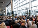 People queue inside Terminal 2 at Dublin Airport, following its reopening after it was evacuated as a safety precaution.