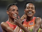 Kenyans Beatrice Chebet , left, and Faith Kipyegon celebrate after the women's 5,000 metres final. (AP)