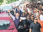 Prime Minister Narendra Modi waves to the gathering during a roadshow in Bhavnagar, Gujarat, on Saturday. (ANI)