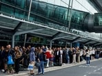 People queue to enter Terminal 2 at Dublin Airport, following its reopening after it was evacuated as a safety precaution.