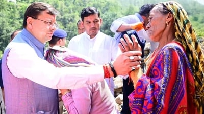 Uttarakhand Chief Minister Pushkar Singh Dhami interacts with residents during his visit to disaster-affected Nandanagar in Chamoli district on Saturday.