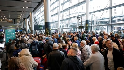 People queue inside Terminal 2 at Dublin Airport, following its reopening after it was evacuated as a safety precaution. (REUTERS)