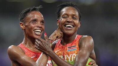 Kenyans Beatrice Chebet , left, and Faith Kipyegon celebrate after the women's 5,000 metres final. (AP) Kenyans Beatrice Chebet , left, and Faith Kipyegon celebrate after the women's 5,000 metres final. (AP)