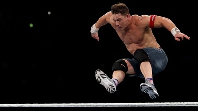 John Cena jumps off the top rope during a match. (Getty Images via AFP) John Cena jumps off the top rope during a match. (Getty Images via AFP)