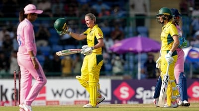 Australia's Beth Mooney, back left, celebrates her century with Ashleigh Gardner, right. (PTI) Australia's Beth Mooney, back left, celebrates her century with Ashleigh Gardner, right. (PTI)