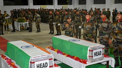 Security personnel pay tribute to the mortal remains of two jawans of the Assam Rifles who were killed when a group of armed men ambushed a vehicle of the paramilitary force (PTI)