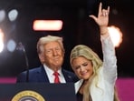 President Donald Trump, left, stands with Erika Kurk at the conclusion of a memorial for her husband