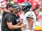 Philadelphia Eagles head coach Nick Sirianni and offenisve coordinator Kevin Patullo speak with Philadelphia Eagles quarterback Jalen Hurts 