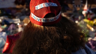 A mourner wears a hat reading "freedom prove me wrong" at a memorial outside of Turning Point USA headquarters in Phoenix, Arizona, US, on Saturday, Sept. 20, 2025. (Bloomberg) A mourner wears a hat reading "freedom prove me wrong" at a memorial outside of Turning Point USA headquarters in Phoenix, Arizona, US, on Saturday, Sept. 20, 2025. (Bloomberg)