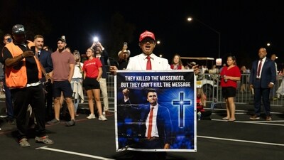 An attendee holds a sign while waiting in line to enter a memorial service for Turning Point USA founder Charlie Kirk at State Farm Stadium in Glendale, Arizona, US, on Sunday, Sept. 21, 2025. President Donald Trump is set to eulogize Charlie Kirk as a patriot and Christian martyr on Sunday as the political activist's assassination continues to galvanize conservative support for the president. Photographer: Rebecca Noble/Bloomberg (Bloomberg) An attendee holds a sign while waiting in line to enter a memorial service for Turning Point USA founder Charlie Kirk at State Farm Stadium in Glendale, Arizona, US, on Sunday, Sept. 21, 2025. President Donald Trump is set to eulogize Charlie Kirk as a patriot and Christian martyr on Sunday as the political activist's assassination continues to galvanize conservative support for the president. Photographer: Rebecca Noble/Bloomberg (Bloomberg)
