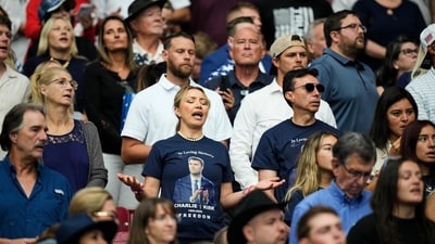 A woman listens during a worship song before the start of a memorial for conservative activist Charlie Kirk (AP) A woman listens during a worship song before the start of a memorial for conservative activist Charlie Kirk (AP)